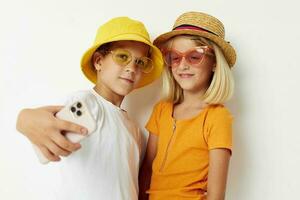 children in hats with phone together friendship photo