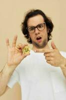 man with glasses gold bitcoin in hands Lifestyle unaltered photo