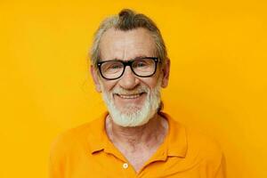 cheerful old man gray beard glasses yellow background photo