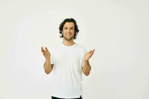 Cheerful man in a white T-shirt communication by phone light background photo