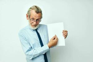 Portrait elderly man holding documents with a sheet of paper cropped view photo