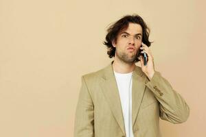 man communication by phone beige suit elegant style isolated background photo