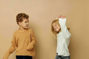 Little boy and girl gesticulate with their hands together Lifestyle unaltered photo