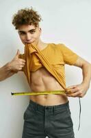 handsome guy grimace measuring tape posing Lifestyle unaltered photo