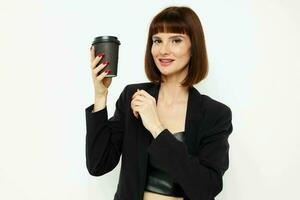 beautiful woman in a black suit a mug with a drink charm Lifestyle unaltered photo