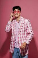 handsome guy in pink glasses pink blazer posing studio isolated background unaltered photo