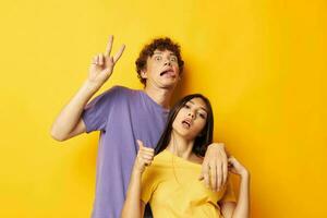 cute young couple in colorful t-shirts posing friendship fun isolated background unaltered photo