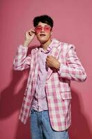 handsome guy in pink glasses pink blazer posing studio isolated background unaltered photo