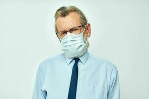 Senior grey-haired man in shirt with tie medical mask safety isolated background photo