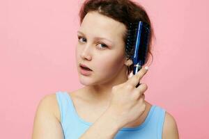 Young woman in blue t-shirts comb with hair emotions isolated background unaltered photo