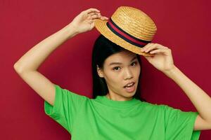 woman in a green t-shirt gesturing with his hands fun red background unaltered photo