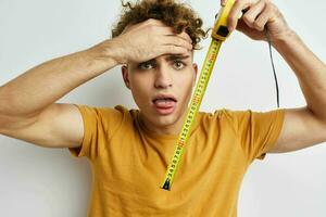 handsome guy grimace measuring tape posing Lifestyle unaltered photo