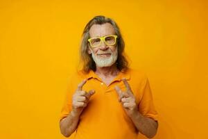 Portrait of happy senior man in yellow glasses with a gray beard emotions cropped view photo