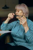 Beautiful mature senior woman sitting in a cafe with a cup of coffee and a laptop Lifestyle unaltered photo