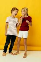 picture of positive boy and girl cuddling fashion childhood entertainment on colored background photo