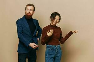 Man and woman couple in a relationship smile and interaction on a beige background in a real relationship between people photo