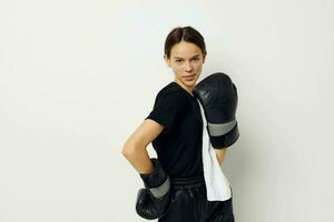 athletic woman in boxing gloves in black pants and a T-shirt isolated background photo