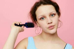 beautiful woman removes hair on a comb dissatisfaction isolated background unaltered photo