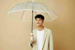 nice guy in a jacket with an open umbrella protection from the rain photo