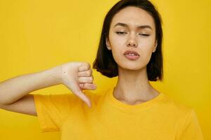 short haired brunette in a yellow t-shirt Youth style casual yellow background photo