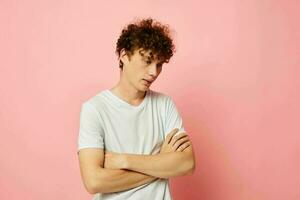 portrait of a young curly man posing youth style white t-shirt isolated background unaltered photo