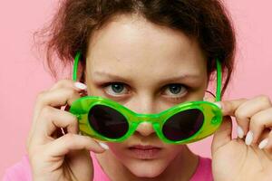 Stylish teenager girl model Youth clothing green sunglasses posing modern style photo