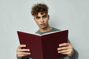 young guy with book learning education posing photo