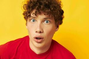 cute red-haired guy in a red t-shirt with a fashion hat isolated background unaltered photo