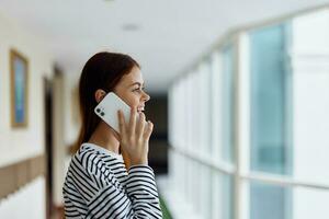 Happy woman smile with teeth talking on the phone portrait, talking on a smart phone over the internet photo