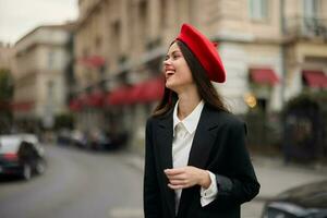 Fashion woman smile with teeth standing on the street in front of the city tourist in stylish clothes with red lips and red beret, travel, cinematic color, retro vintage style, urban fashion. photo