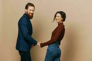 Man and woman couple in a relationship smile and interaction on a beige background in a real relationship between people photo