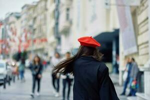 Happiness woman jumps and runs, follow me walks walks in the city against the backdrop of office buildings, stylish fashionable vintage clothes and make-up, spring walk, travel. photo