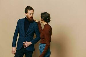 Man and woman couple in a relationship smile and interaction on a beige background in a real relationship between people photo