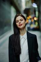 Fashion woman smile with teeth portrait looking at camera tourist in stylish clothes in jacket with red lips walking down narrow city street flying hair, travel, cinematic color, retro vintage style. photo