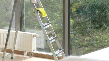 Metallic ladder and tools for cleaning the window glass video