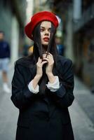 Fashion woman portrait walking tourist in stylish clothes with red lips walking down narrow city street, travel, cinematic color, retro vintage style, dramatic look without smile sadness. photo