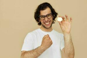 handsome man with glasses gold bitcoin in hands isolated background photo