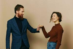 Man and woman couple in a relationship smile and interaction on a beige background in a real relationship between people photo