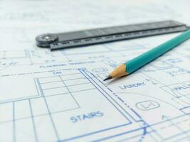 Image of blueprints with level pencil, ruler and magnifier on table photo