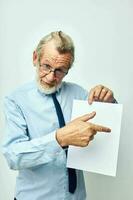 Portrait of happy senior man work office blank sheet of paper light background photo