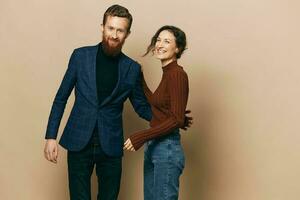 Man and woman couple in a relationship smile and interaction on a beige background in a real relationship between people photo