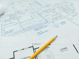 Architectural blueprints and pencil for the project drawings photo