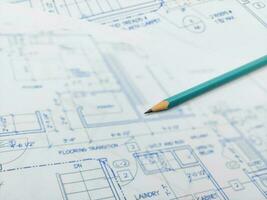 Architectural blueprints and pencil for the project drawings photo
