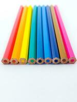 Close-Up Of Colored Pencils On white table photo