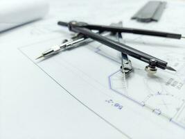 Paper home floor plan with compass. Architectural sketching process concept. Floor plan on architect's desk. photo