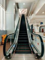 Empty escalator stairs in the public building. photo