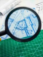 Magnifier glass and floor plan of architectural project photo