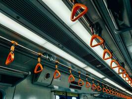 Empty yellow handle grip on public transportation photo