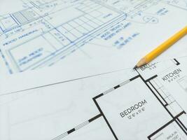 Architectural blueprints and pencil for the project drawings photo