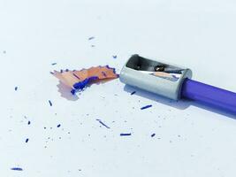 Pencil with sharpening shavings on white background photo